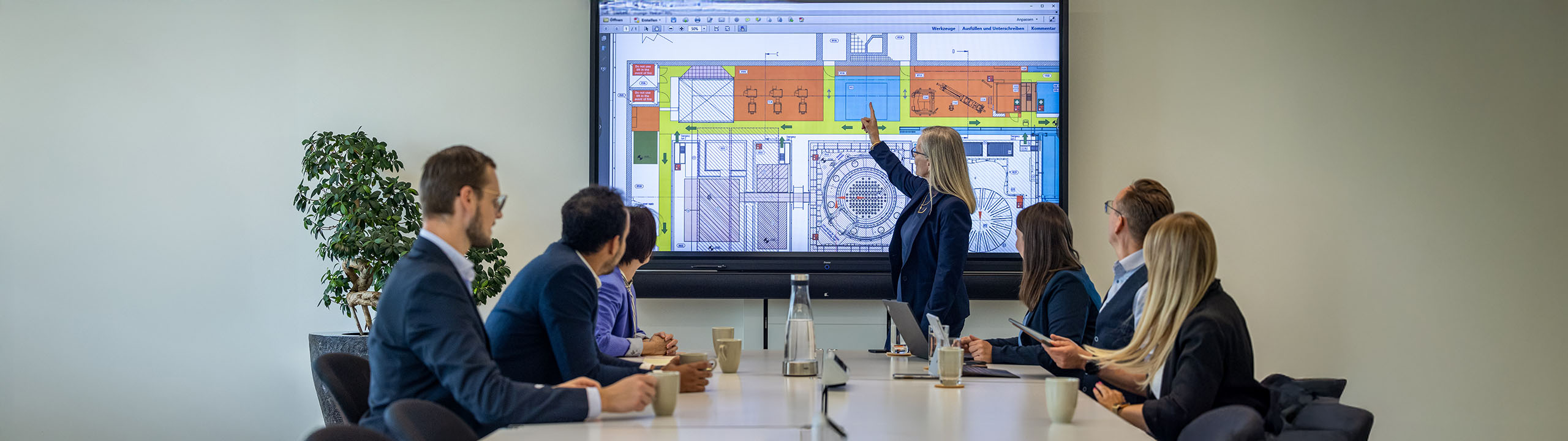 Colleagues sit together in a conference and consult with each other.