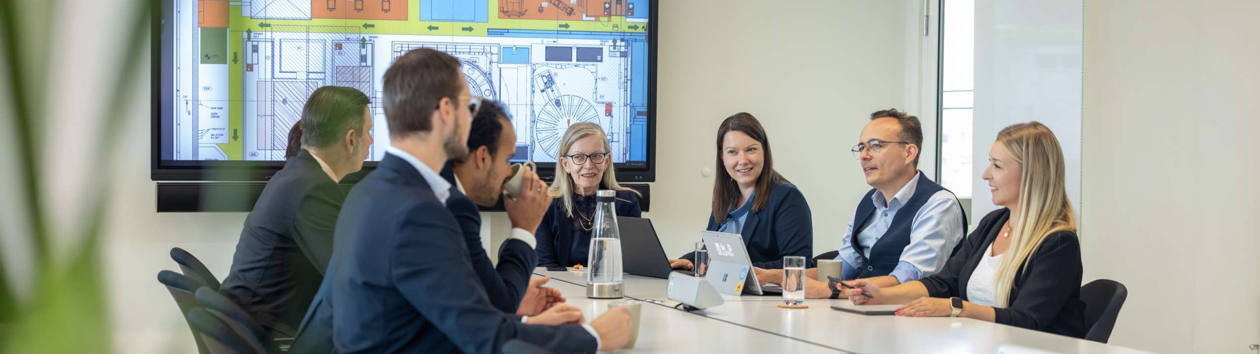 Colleagues sit together in a conference and consult with each other.